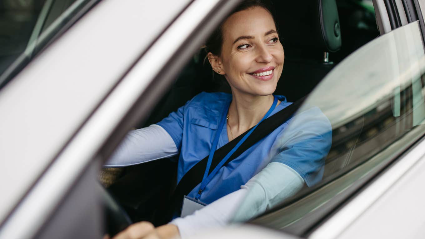 Woman driving home from work in her car.