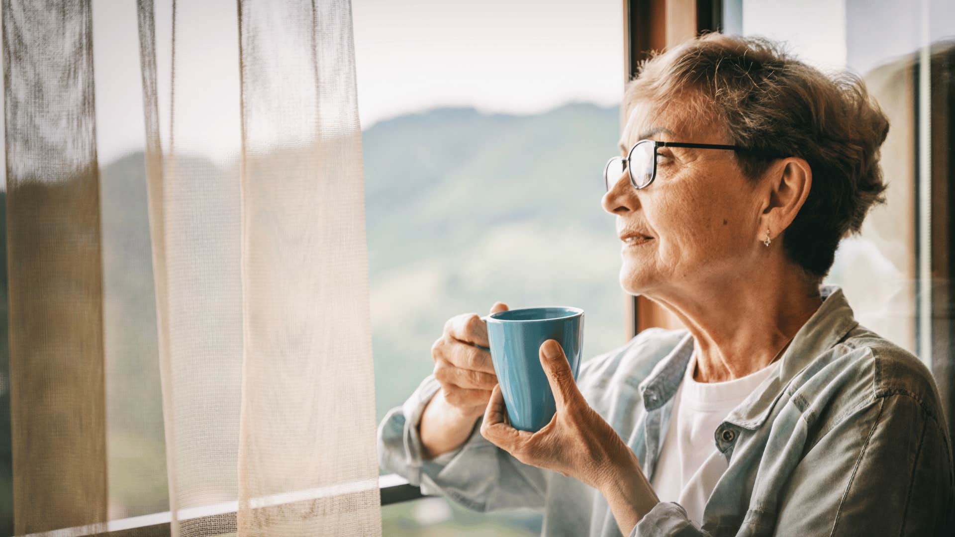 older woman looking out window