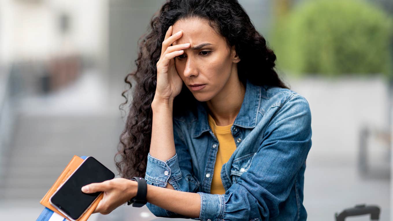 Woman looking frustrated in a parking lot with her HOA. 