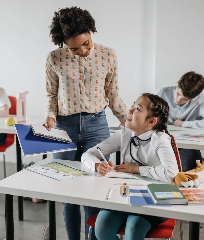 teacher talking to student in the classroom