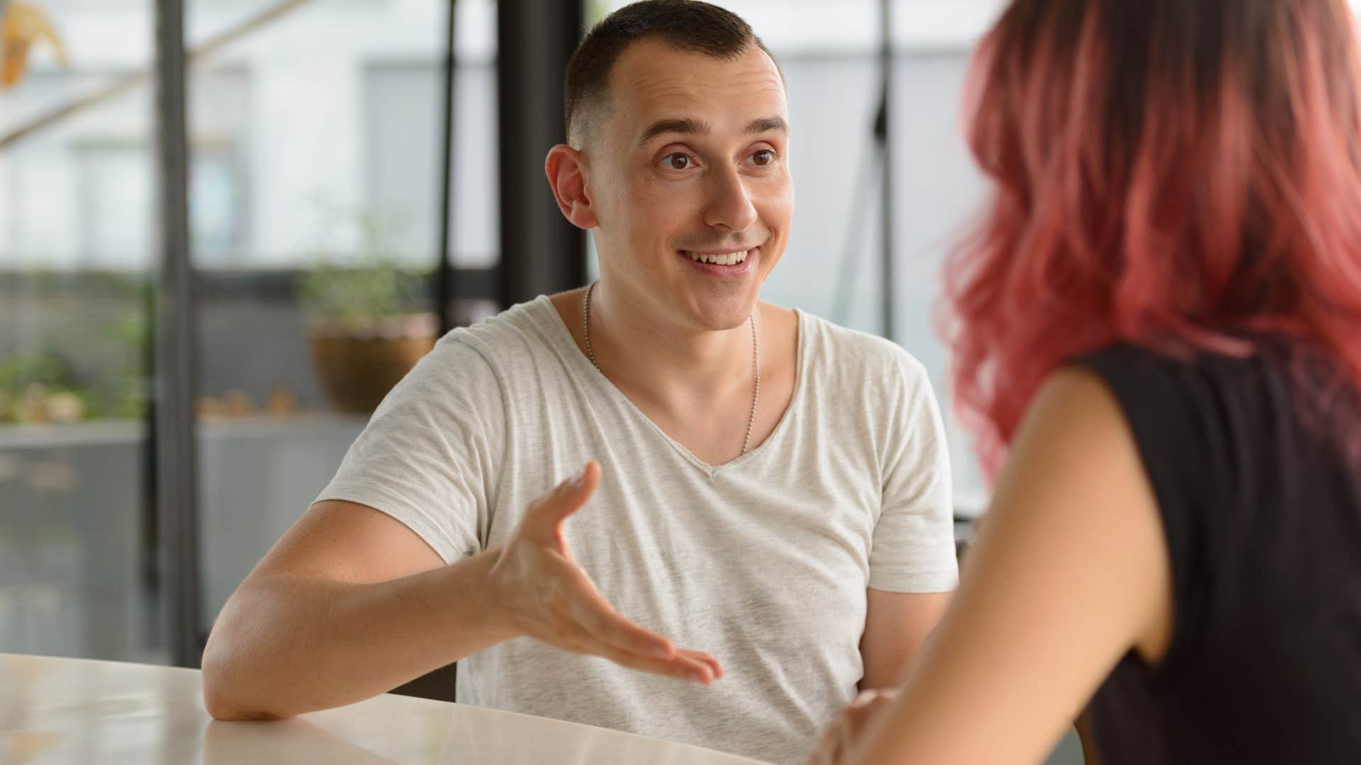 Man confidently talking to a woman.