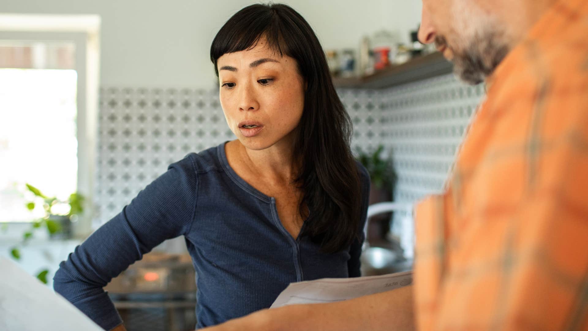 Woman looking annoyed while her partner talks. 