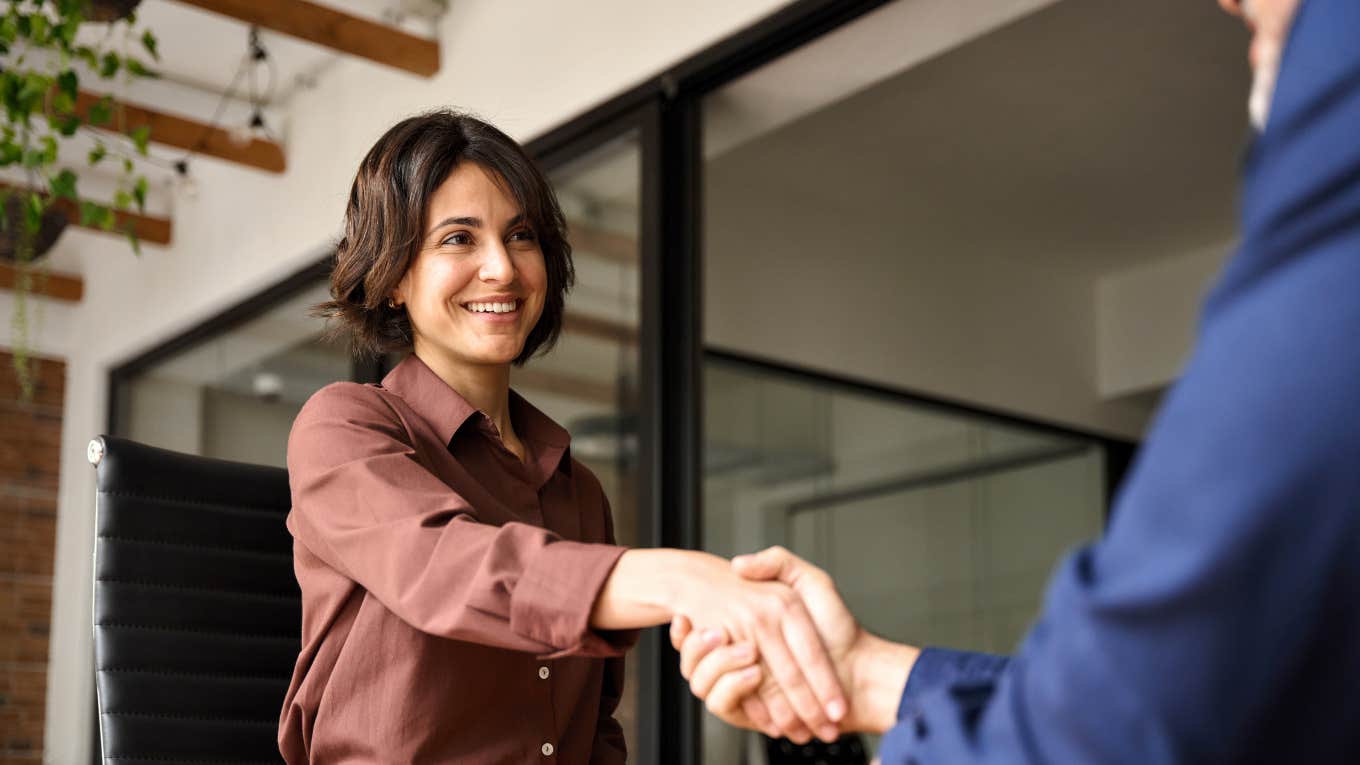 woman shaking man's hand for job interview