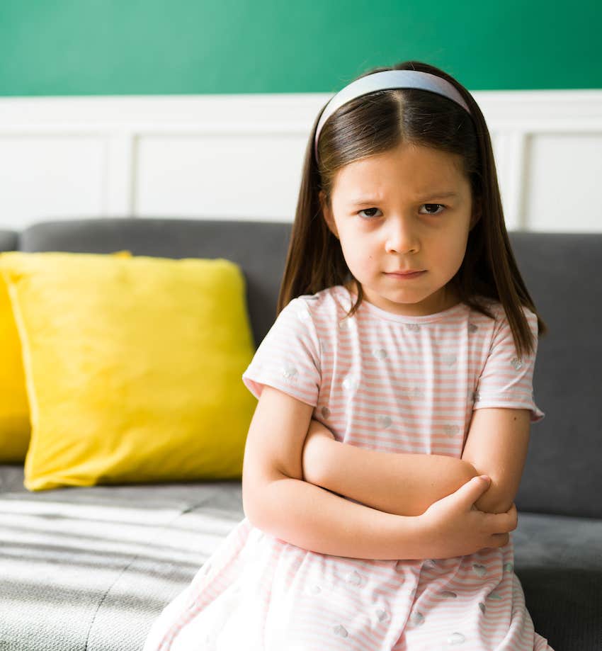 Girl crosses arms and glares at camera