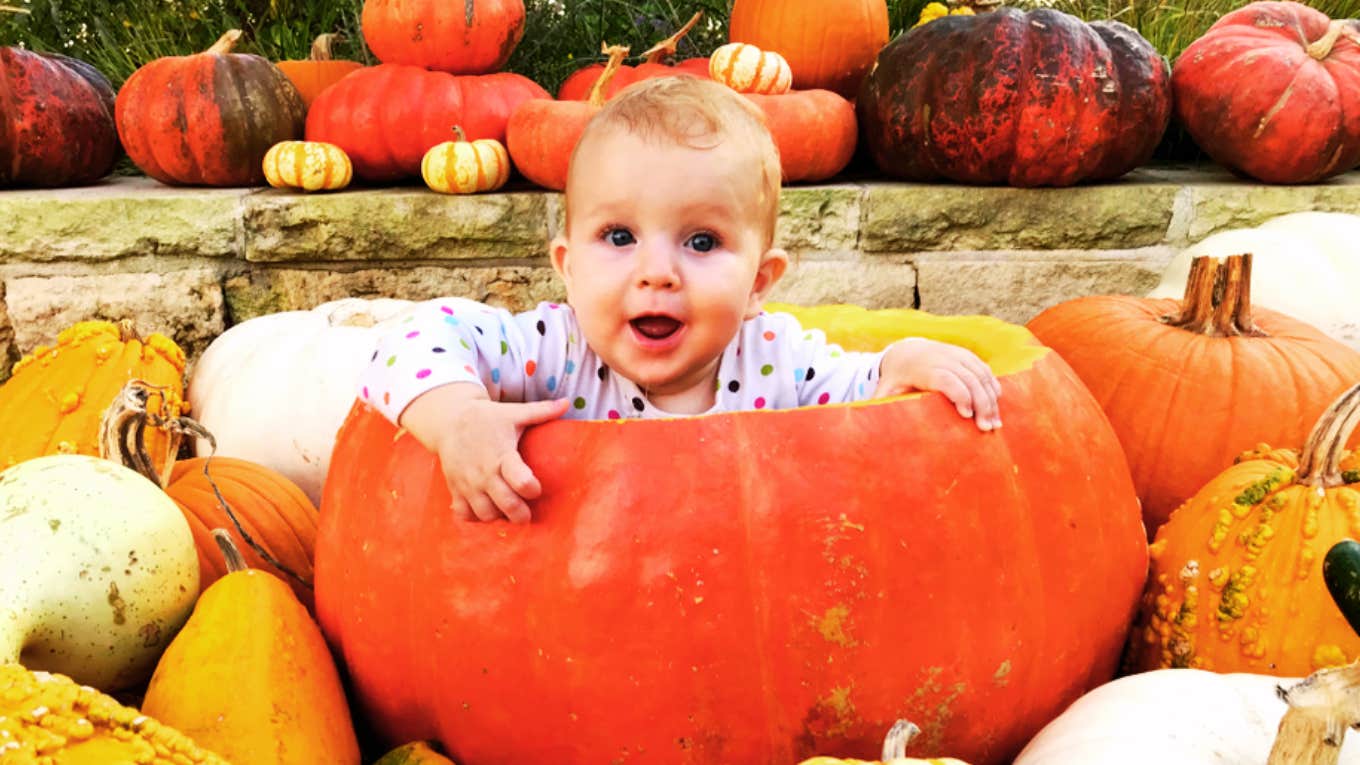 baby in pumpkin at pumpkin patch