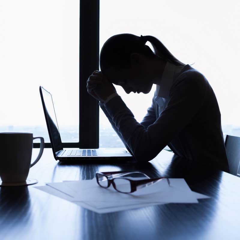 Silhouette of stressed business woman