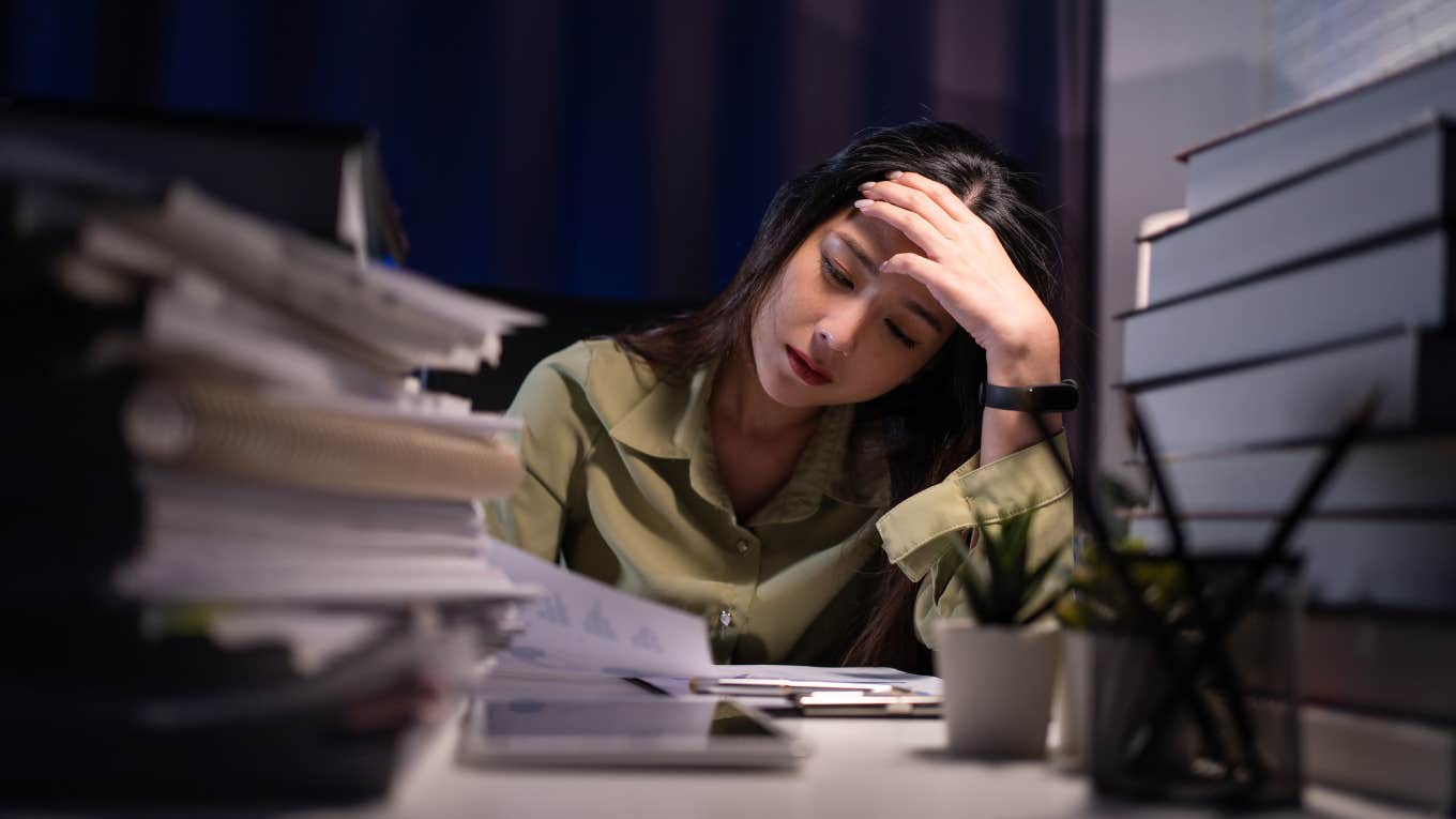 Woman working overtime on a desk at night