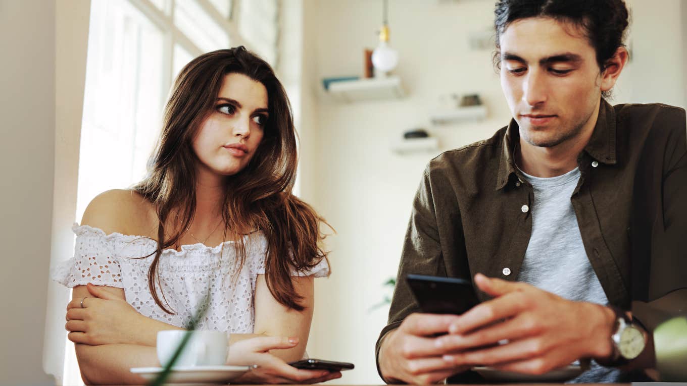 Woman feeling ignored by husband on his phone