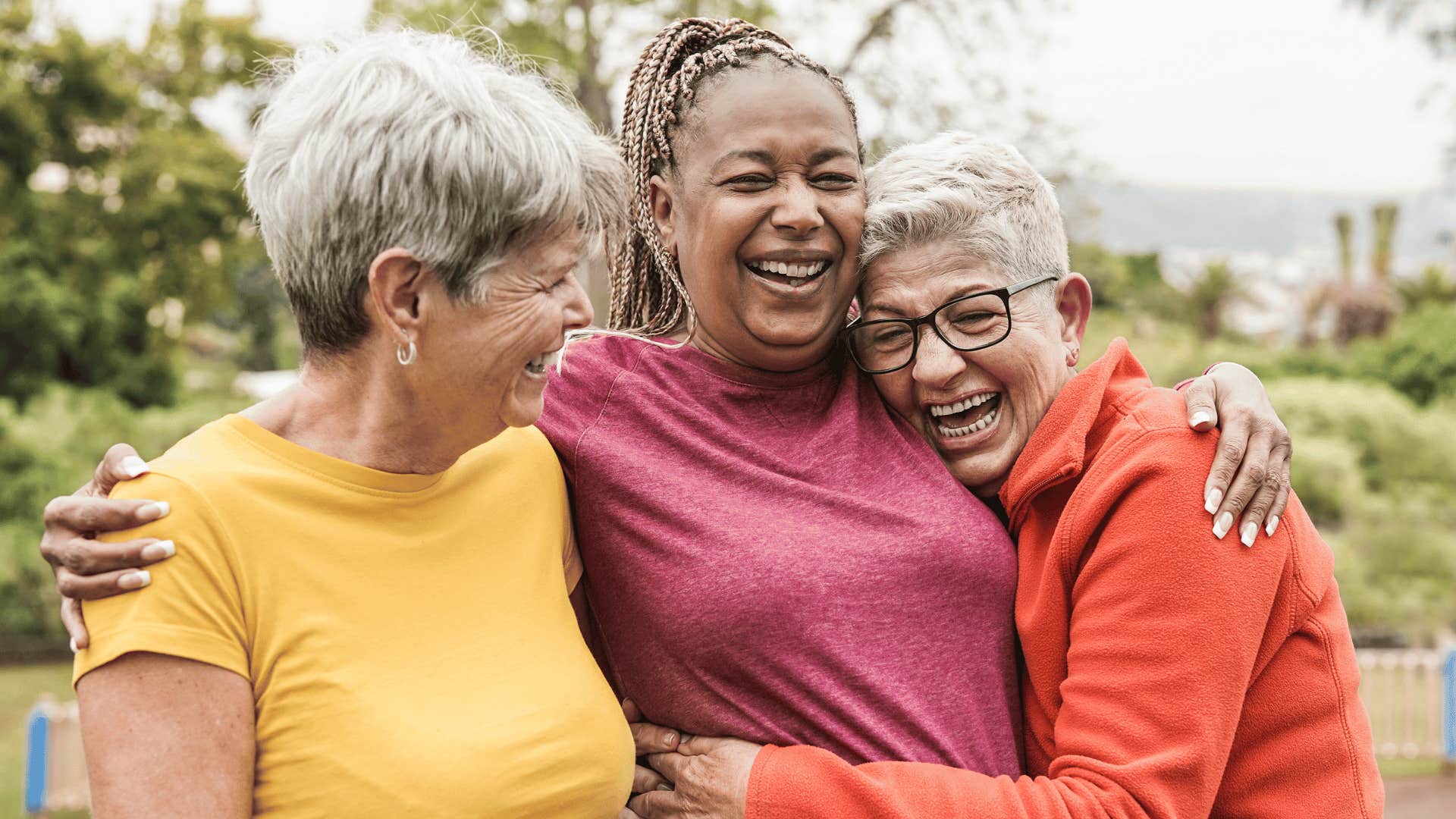 three older female friends smiling