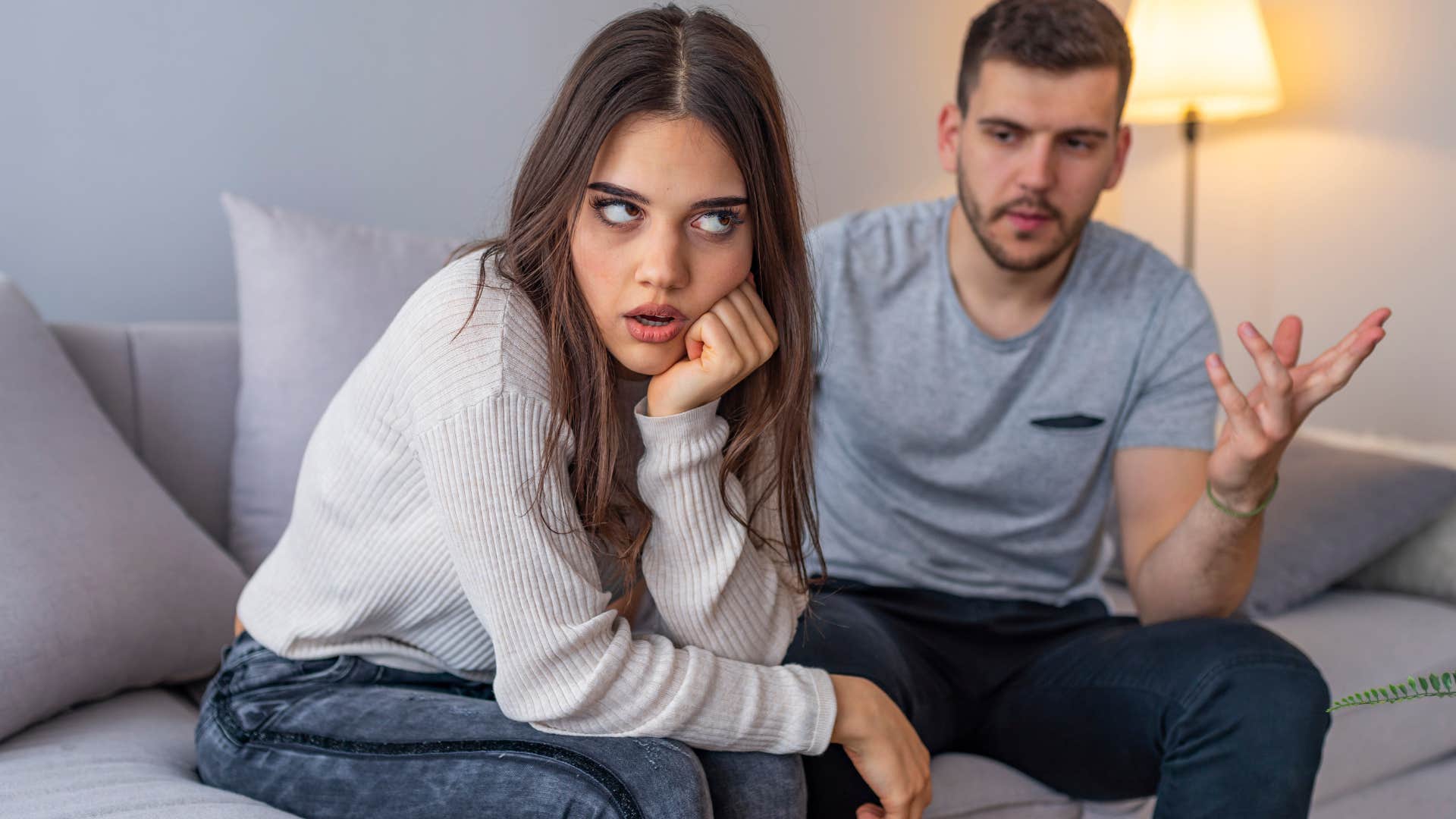 Woman looking annoyed while her boyfriend talks.