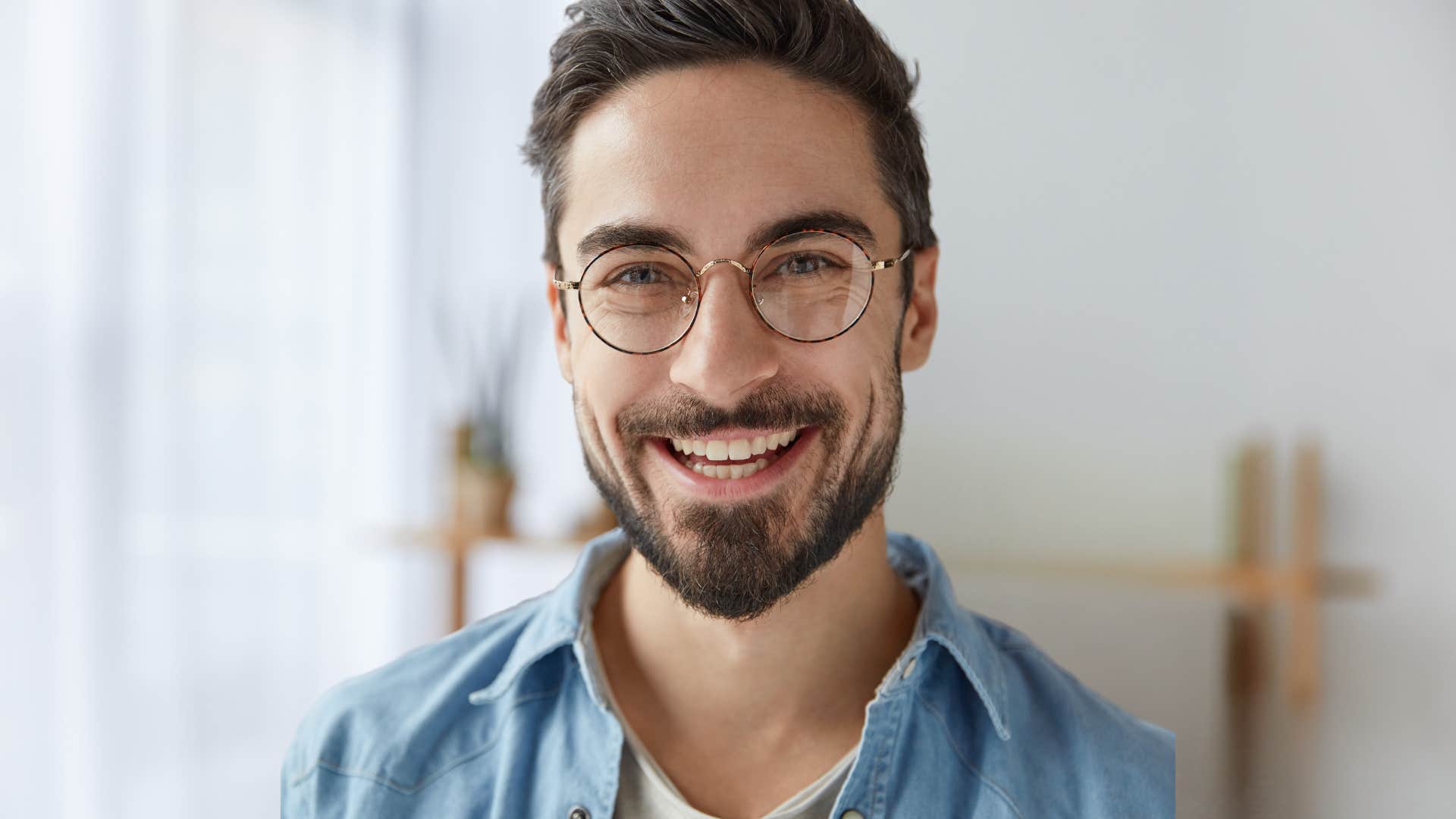 Confident man smiling at home.