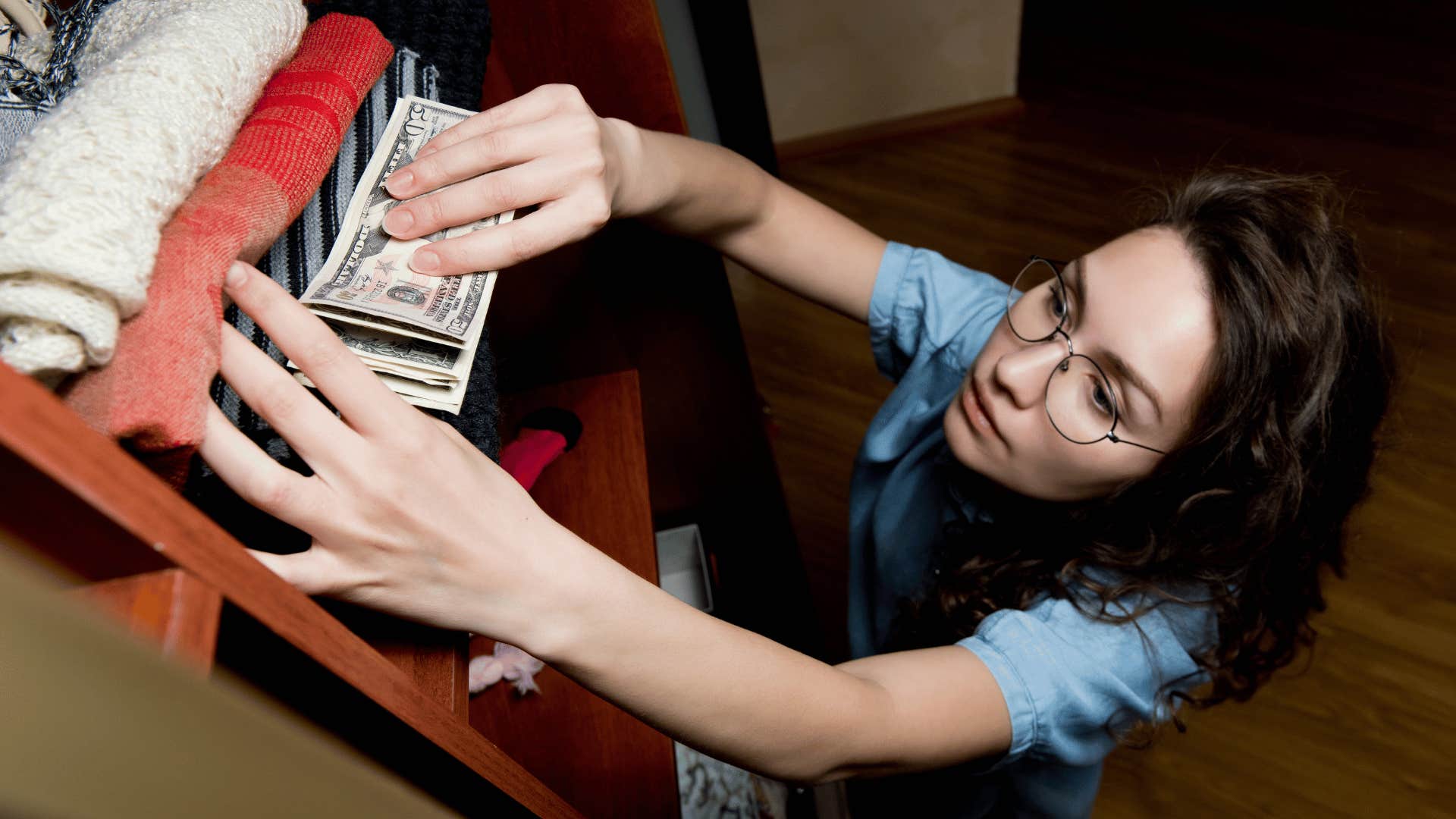 She hides money between towels high on a shelf