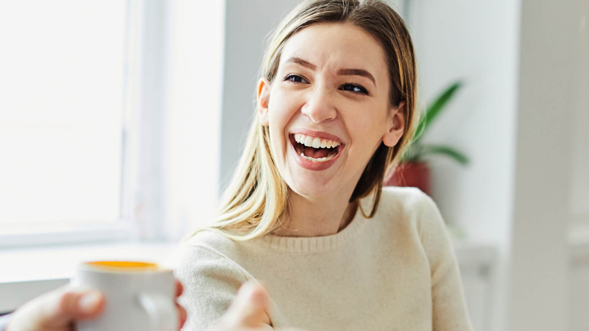 Woman smiling while talking to a person