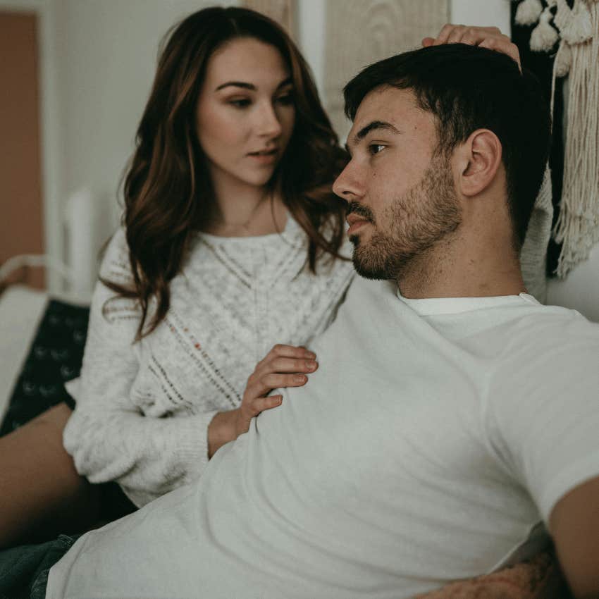 couple sitting close with woman comforting man