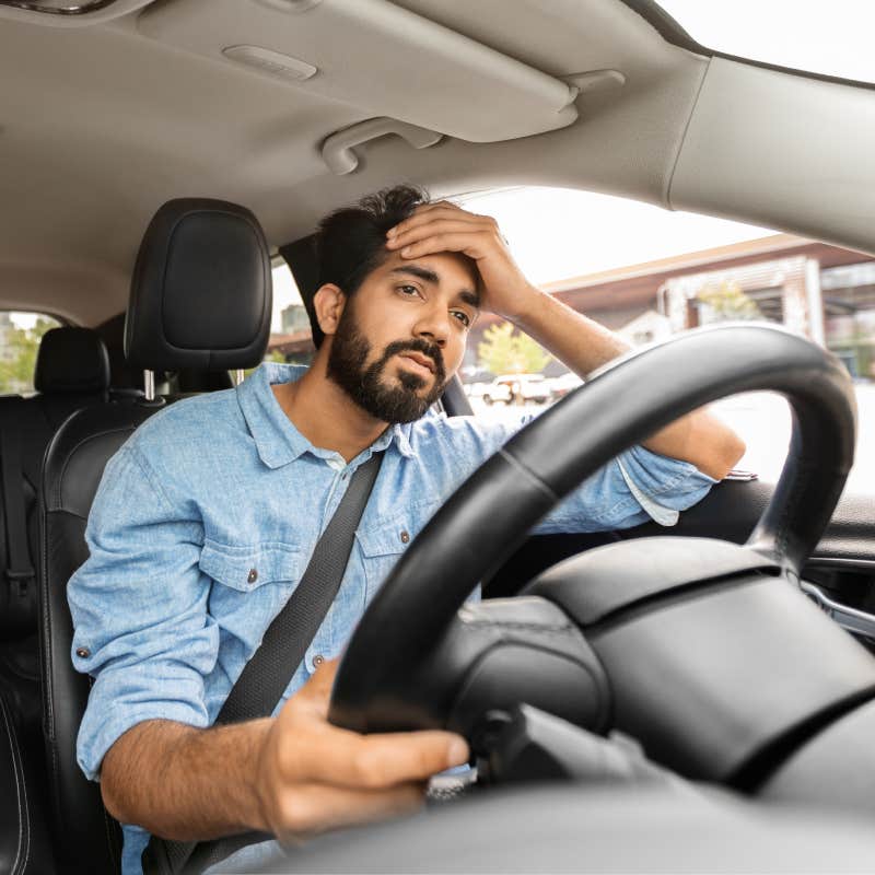 man annoyed sitting in car