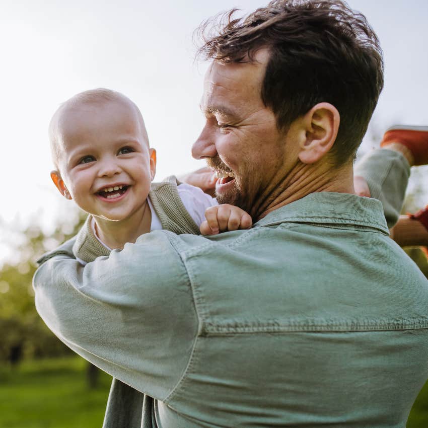 Dad on paternity leave holding baby