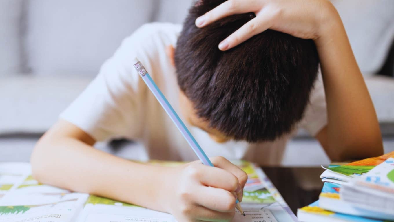 little boy stressed out by homework