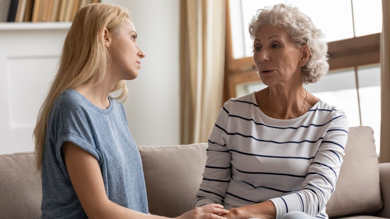 Woman talking to her elderly mother about money