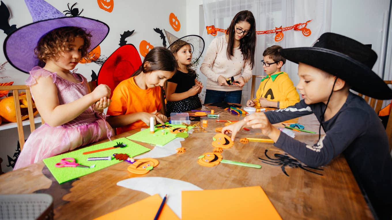 Daycare teacher decorating for Halloween with her kids