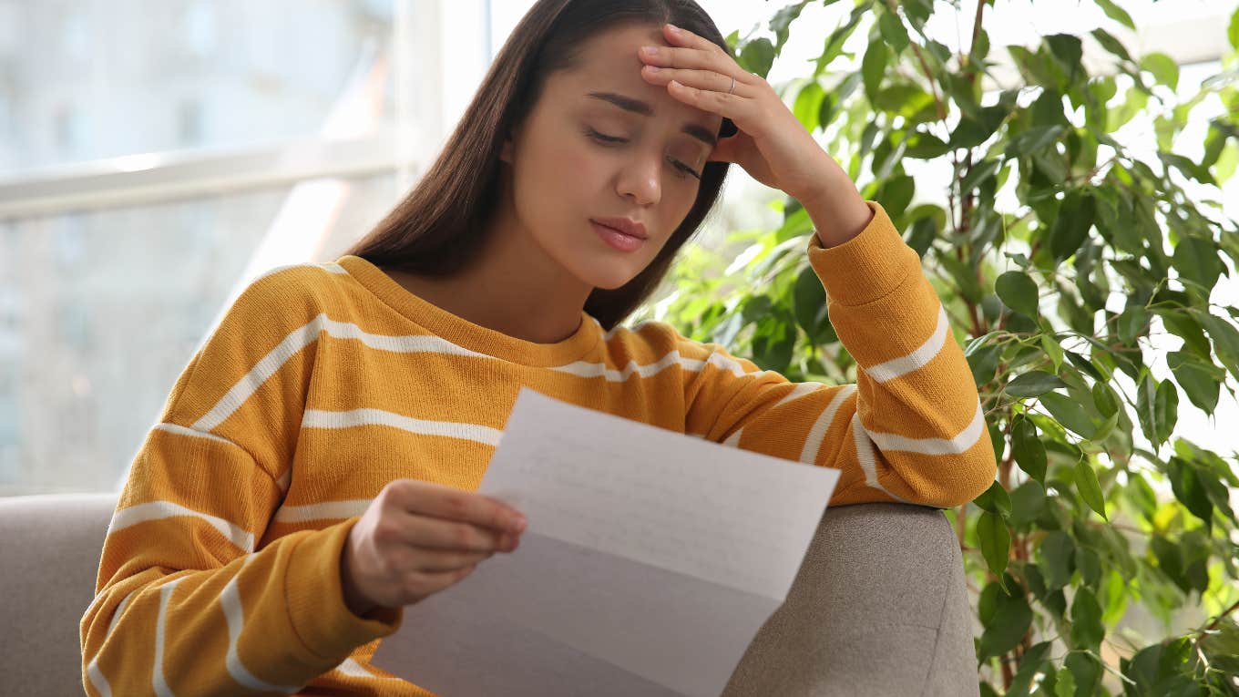 Depressed bartender reading the note from her boss