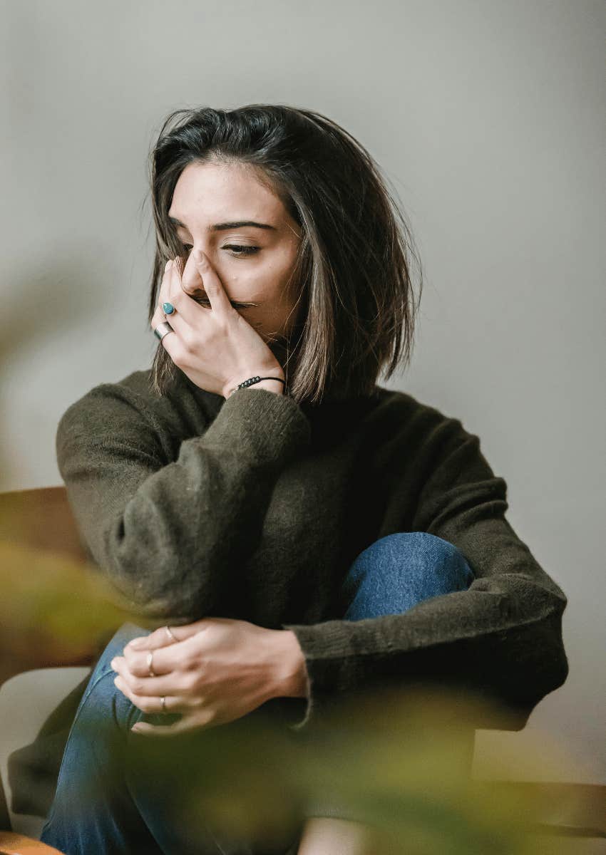 depressed woman hugging her knees to her chest