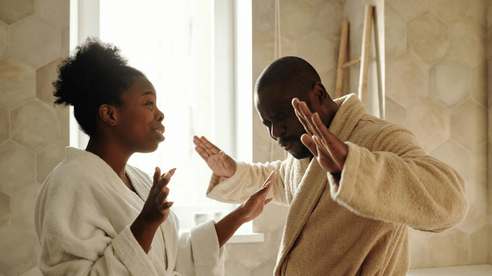 couple fighting in bathrobes