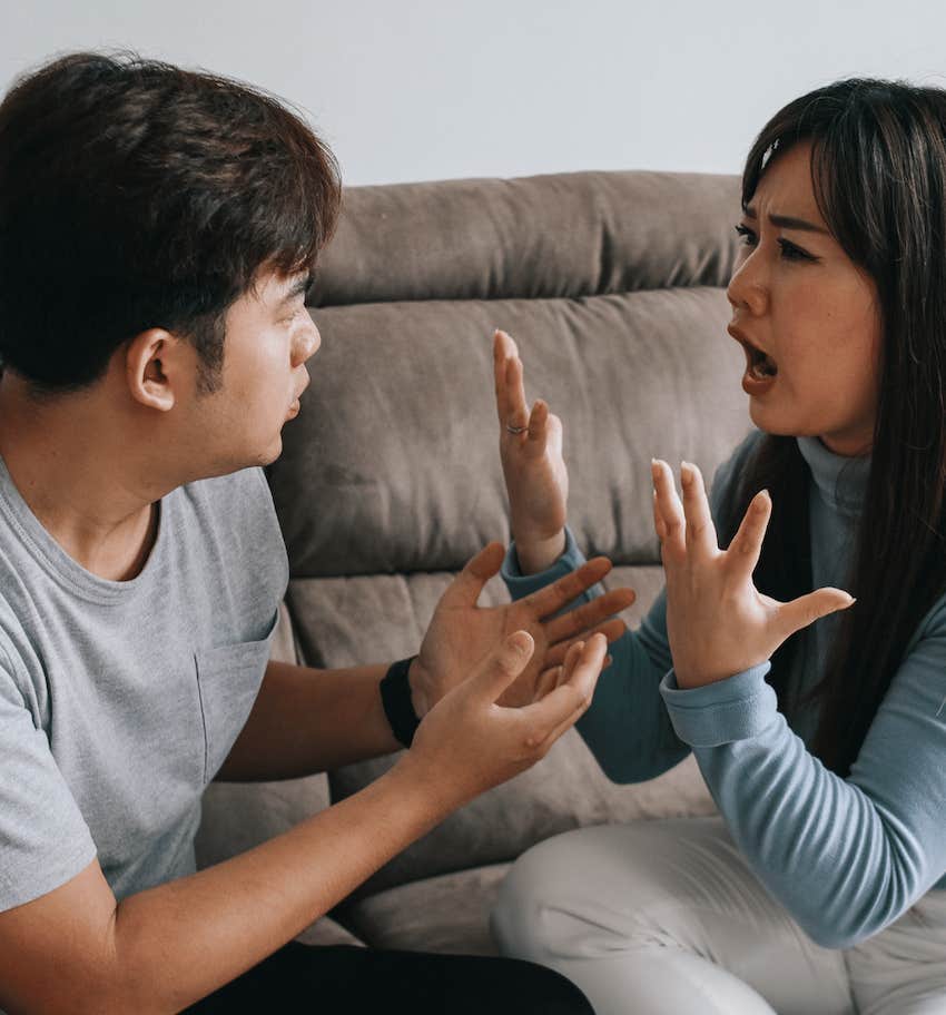 Couple argue and gesture with hands