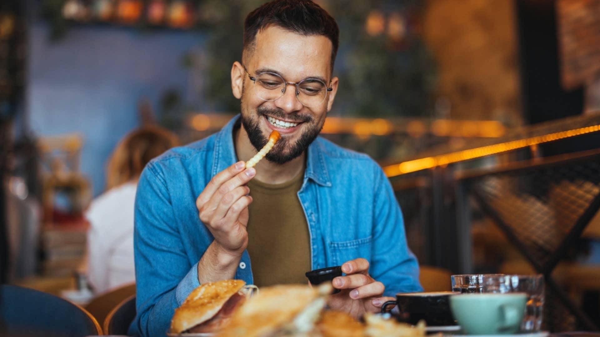 Poor man eating in a restaurant.