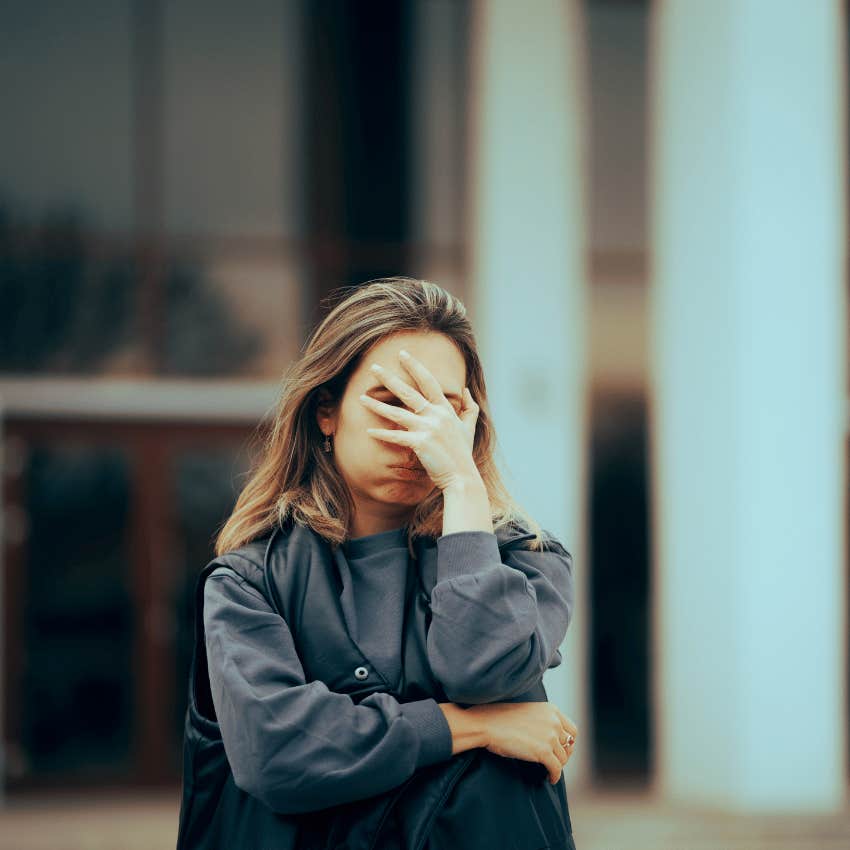 embarrassed woman making a facepalm gesture