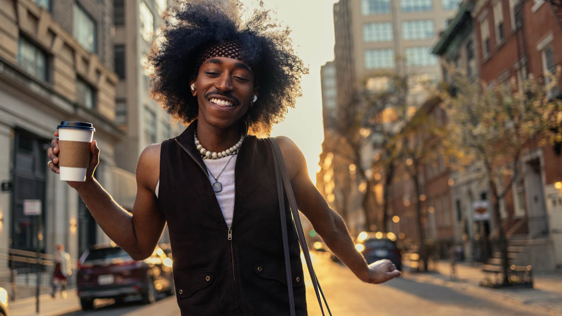 Empathetic man smiling in public. 