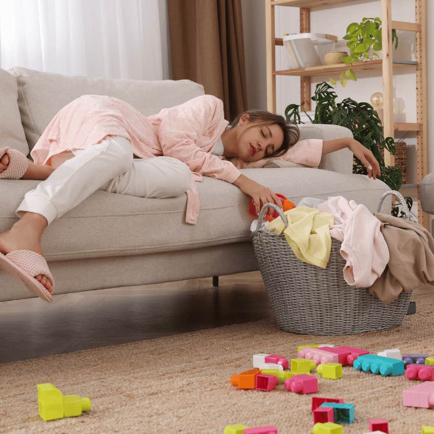 exhausted mom resting while cleaning