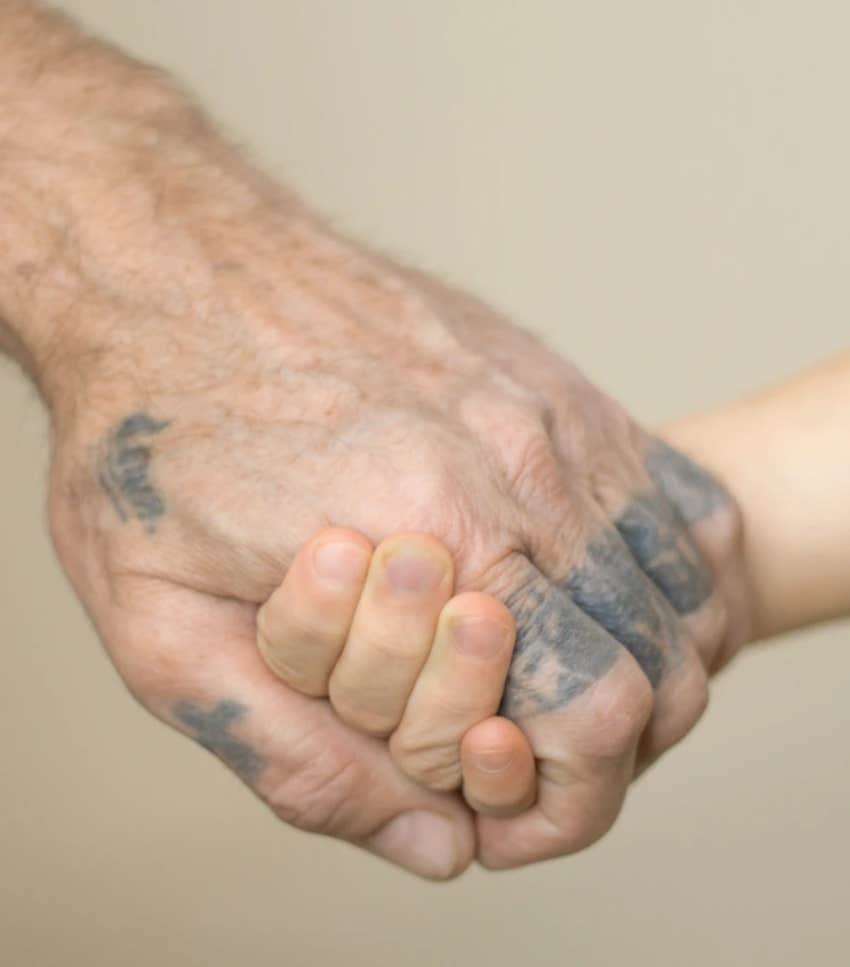 fading hand tattoo on an old man