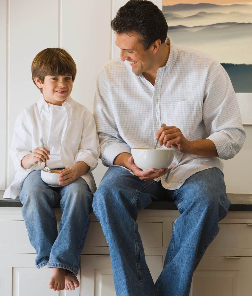 Father and son in matching outfits eating cereal