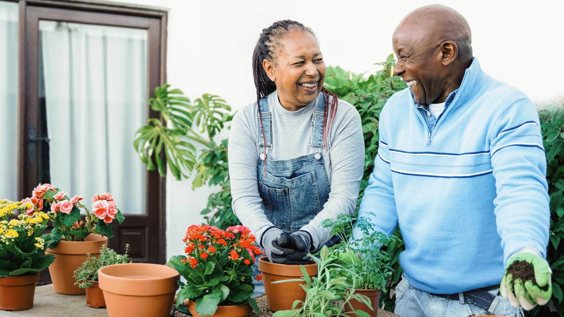 Happy couple repots flowers