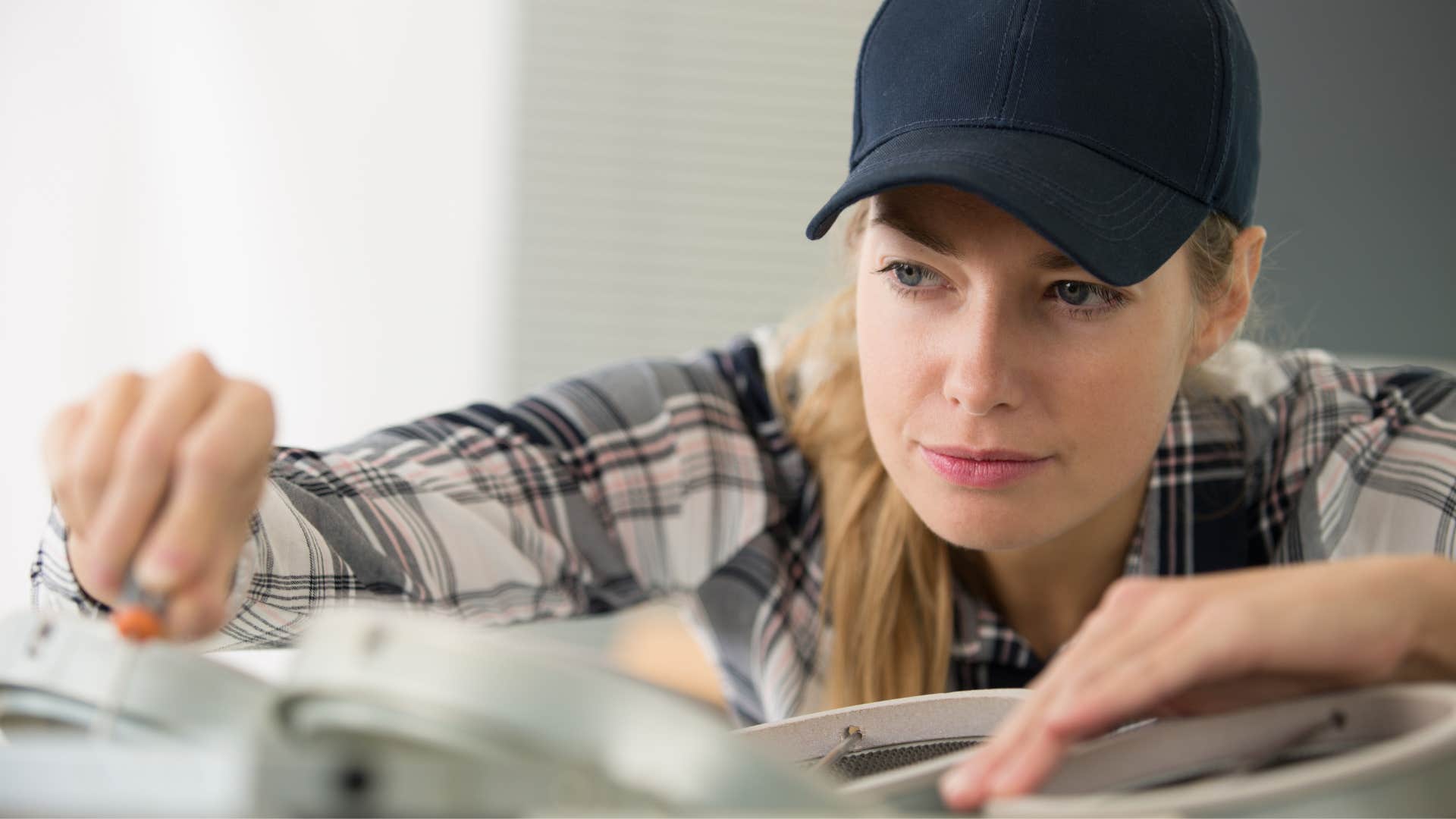 Woman who grew up poor fixing a car. 