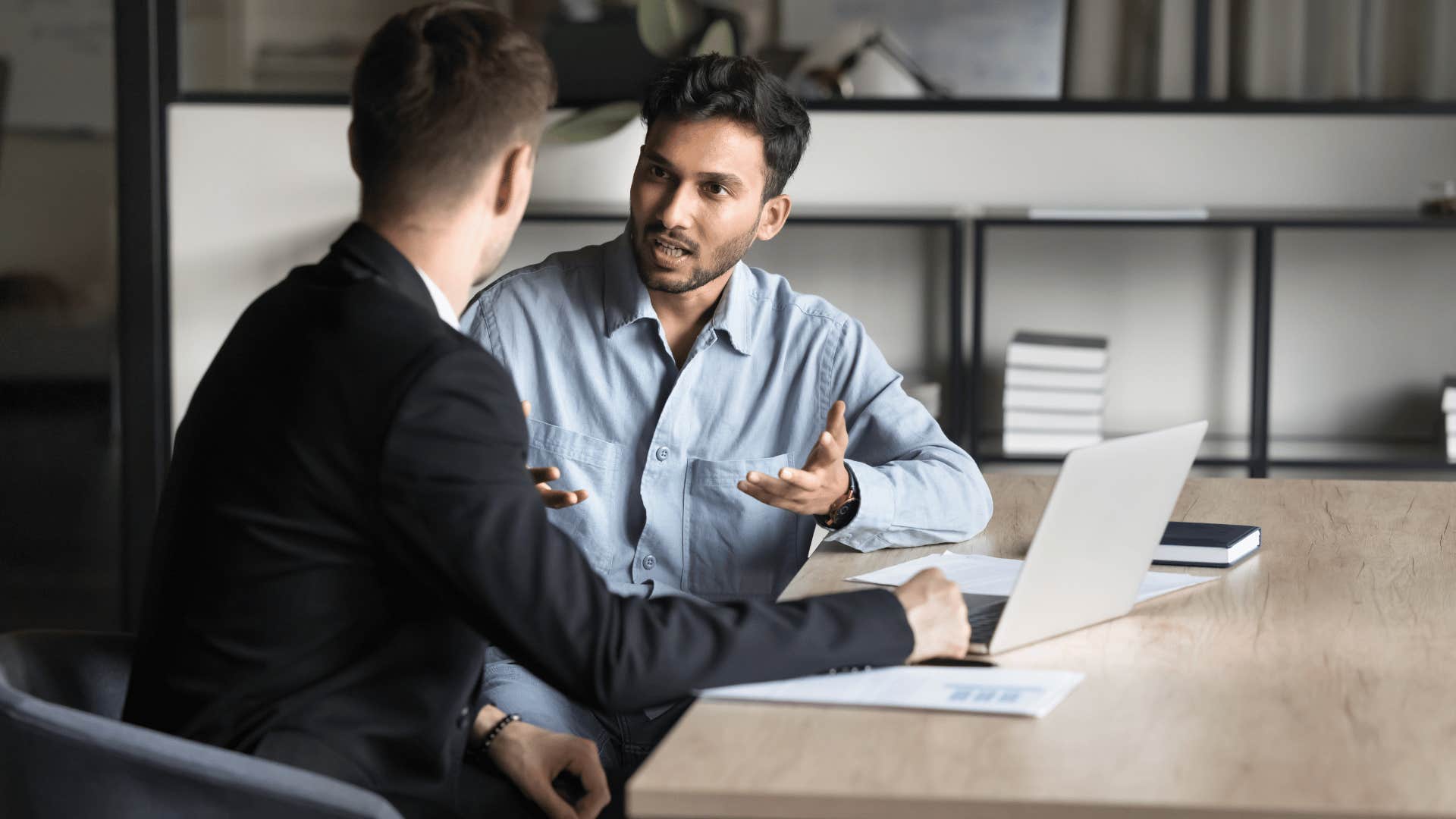 man talking to coworker