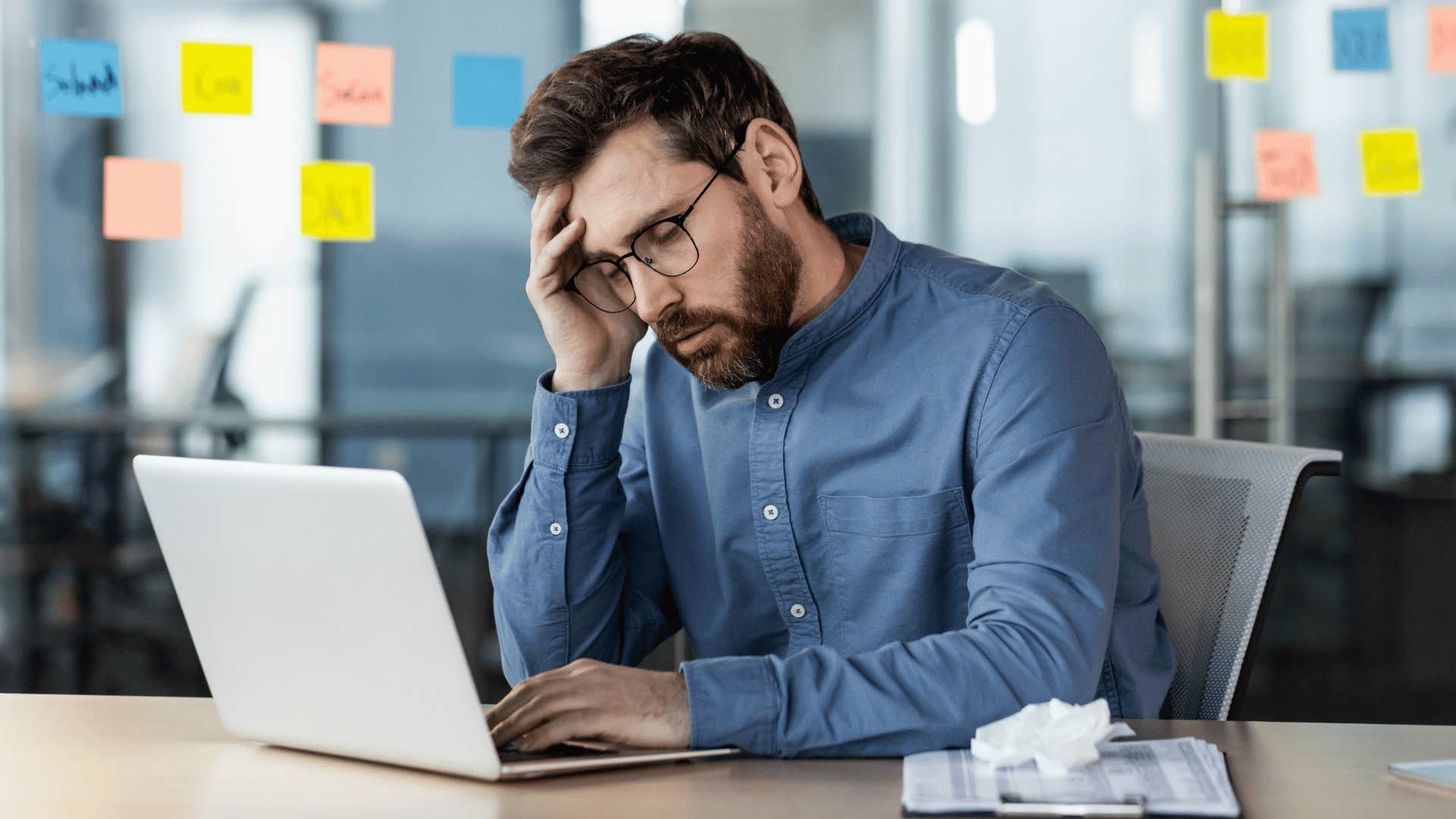 man looking at laptop stressed out