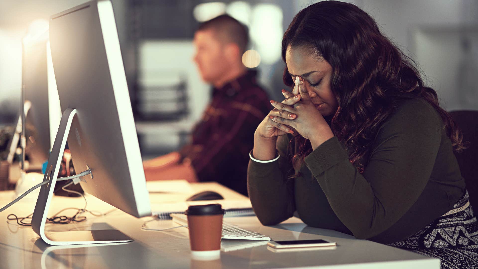 woman looking tired and stressed at work