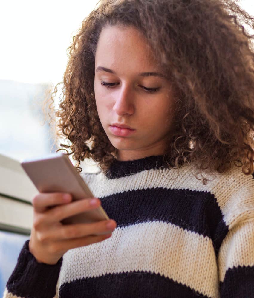 Gen Z woman staring at phone