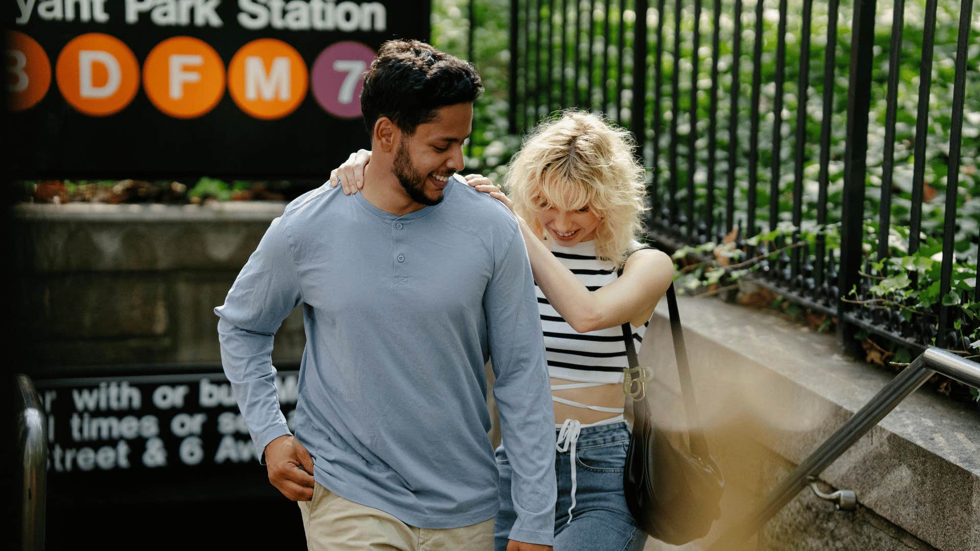 couple walking out of subway