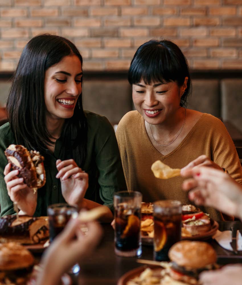 Friends share food at restaurant