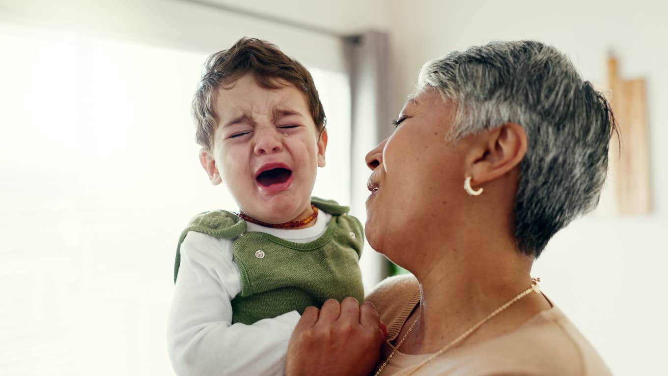 Grandma babysitting crying toddler