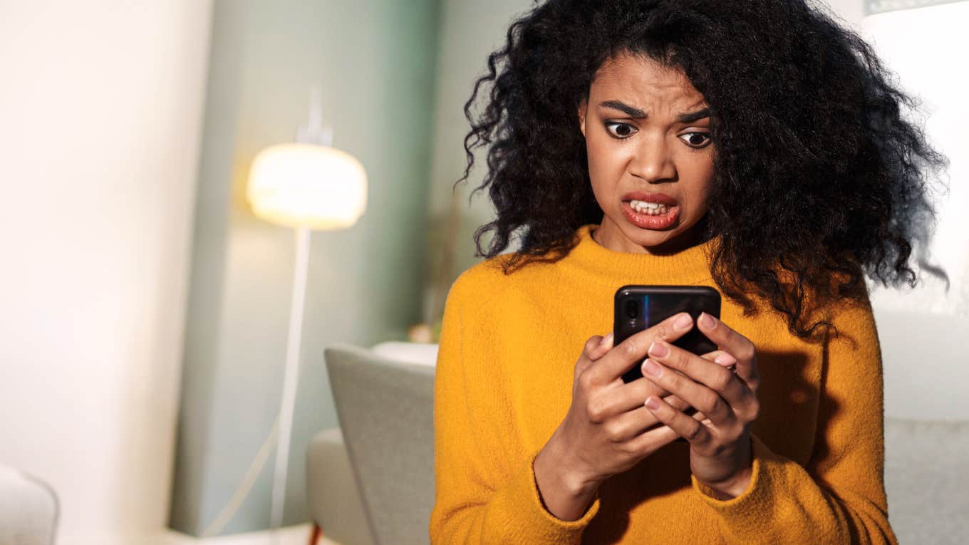 Woman looking at phone because ex is trying to get her back.