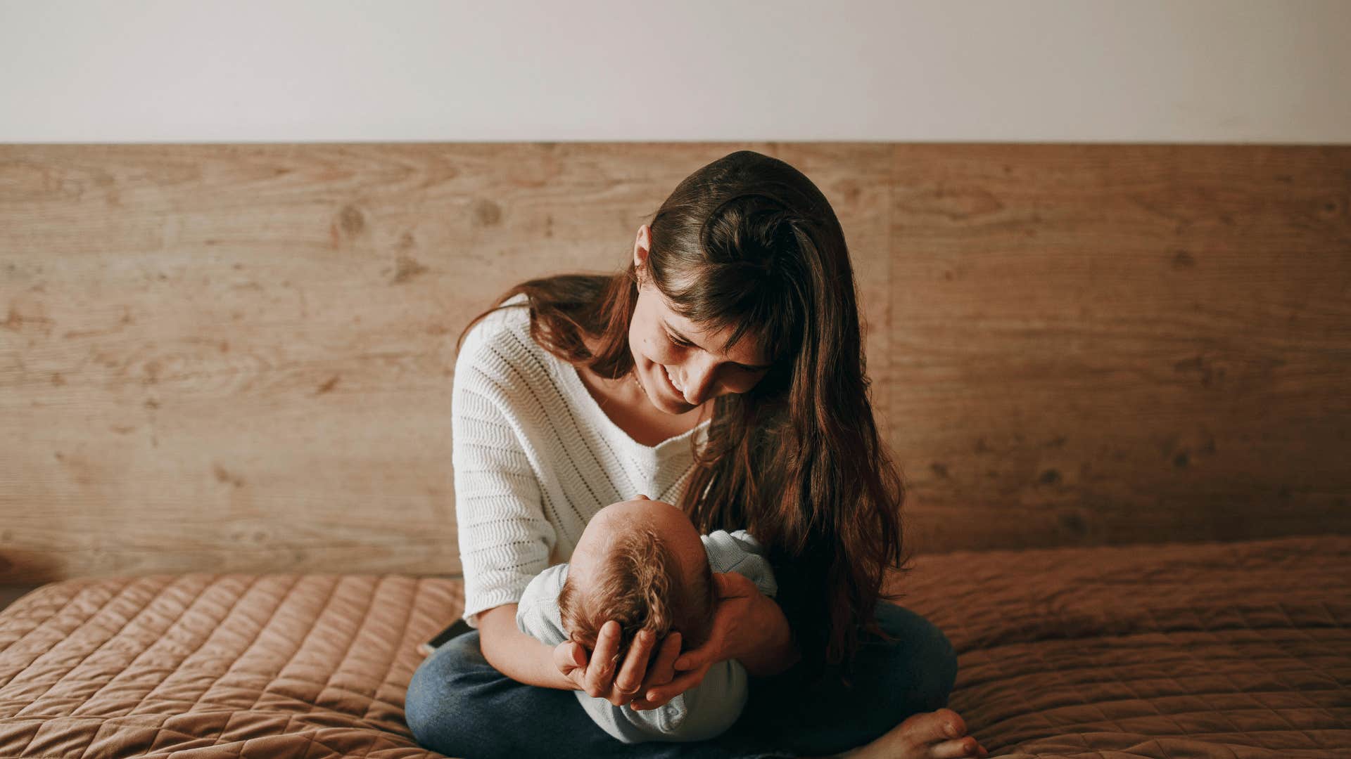 woman with baby on bed