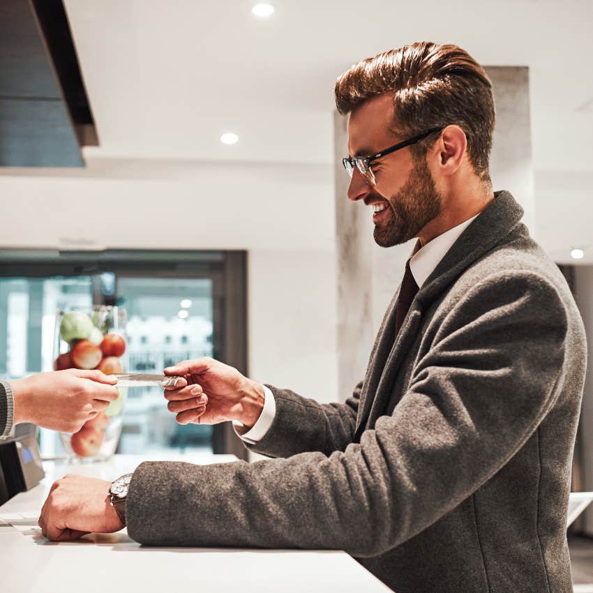 Hotel guest checking in at reception