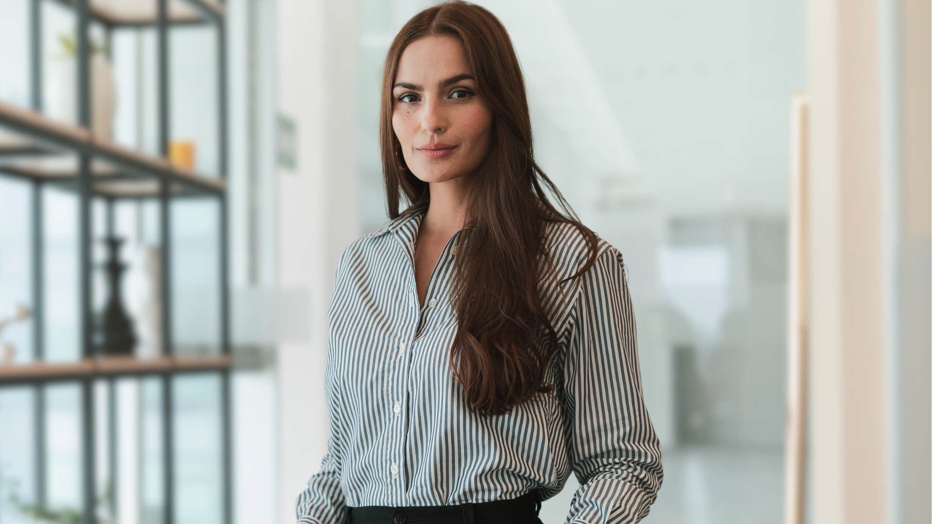 Humble woman smiling alone at work.