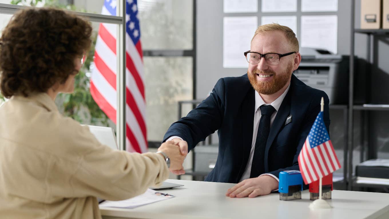 Woman getting United States green card and welcome pamphlet