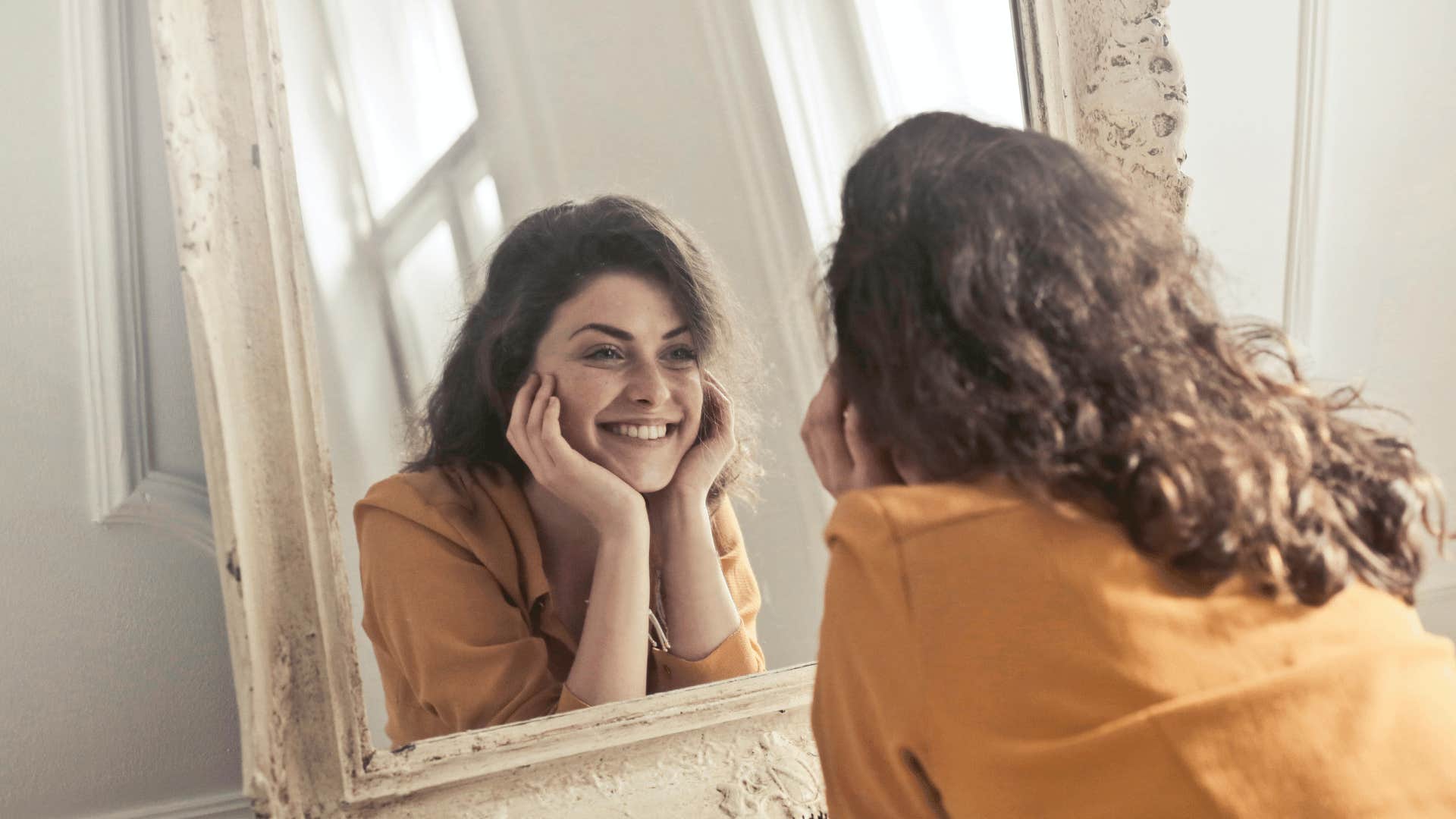 happy woman smiling in mirror