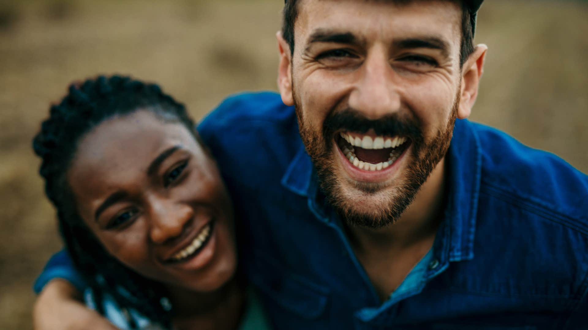 Couple smiling and hugging each other.