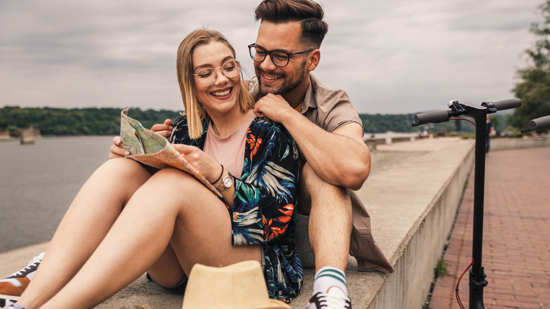 Man and woman sitting together outside.